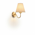 Modern wall sconce light fixture with a brushed brass finish and a tapered fabric shade, shown against a solid white background.